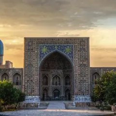 Prachtvolles Gebäude in Usbekistan mit blauen Kuppeln und Mosaiken. Eine Reise dorthin ist trotz der Schönheit lohnenswert, aber eine Usbekistan Reisewarnung sollte beachtet werden.