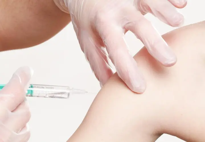 Eine Spritze wird in einen Arm injiziert. Informationen zu Thailand Impfungen Kosten sind wichtig für Reisende.