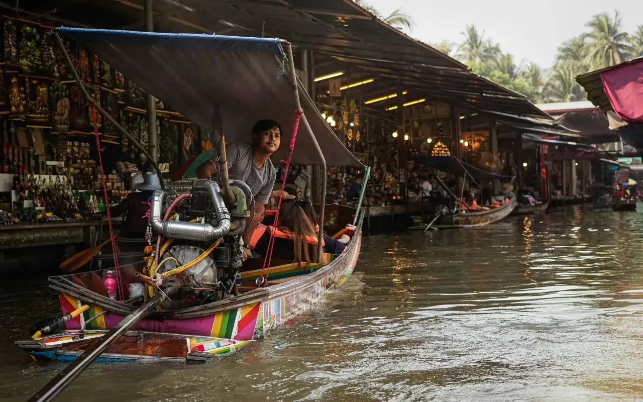 Bunter Kahn mit Motor f&auml;hrt durch einen lebhaften floating market. H&auml;ndler verkaufen Waren von ihren Booten.